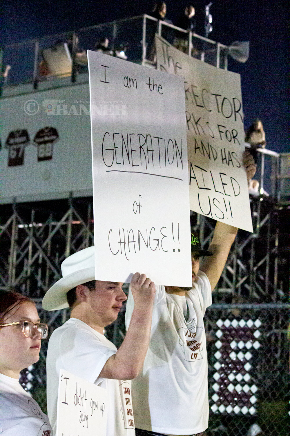 Demonstrators Protest Teacher’s Termination at Homecoming Game